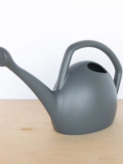 Gray, 2 gallon plastic watering can made from 100% recycled material. Attached spout and ergonomic handle.